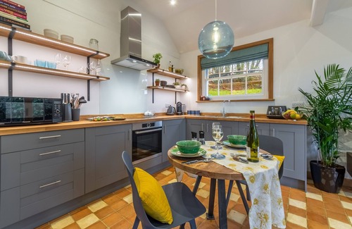 Robertsbridge Cottage | A light and airy property with a hammock and hot tub, situated on a working farm