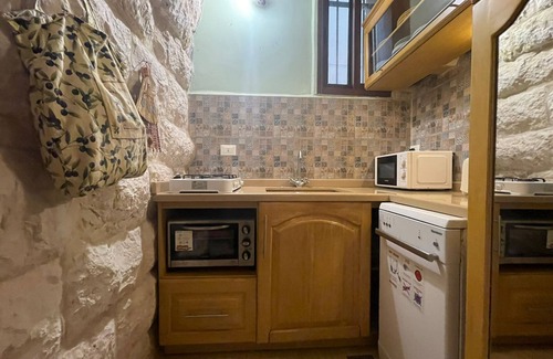 Damour House | A renovated historic rock house with two vaults