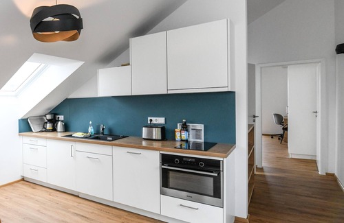 Waggershausen Apartment | Above the rooftops - cozy attic apartment with mountain view and mini balcony.