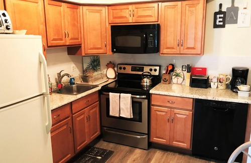 Village Green House | Beautiful corner property with cozy beach vibe.