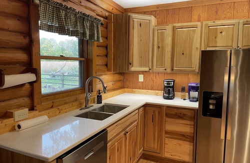 Lawrence Cabin | Beautiful log cabin with all the creature comforts of home. Private fishing lake