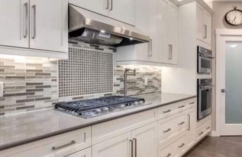 Okotoks House | Bright, spacious family home with great a outdoor space overlooking green space.