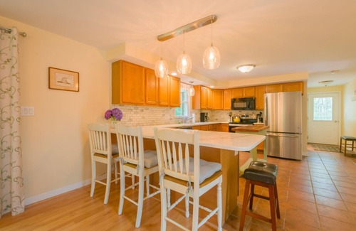 Mashpee House | Cape Cod pet friendly home with deck with gas grill, back yard patio with fire pit, and central AC