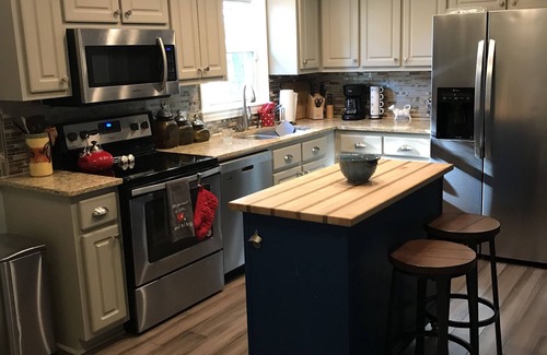 Hillsborough House | Charming brick ranch with spacious fenced yard.