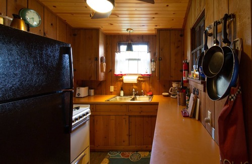 Lake Ripley Cottage | Classic cabin/cottage with big screen porch, stone fireplace, knotty pine walls.