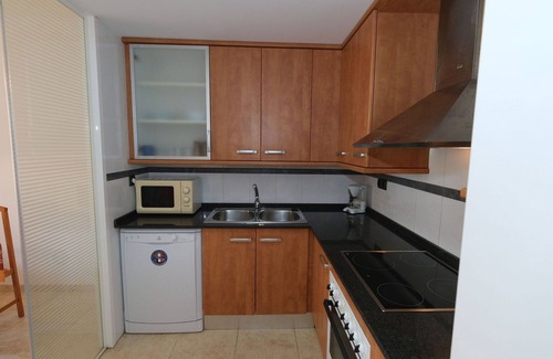 Sant Carles de la Rapita Apartment | Cosy apartment for 3 people with pool, A/C, TV, balcony and parking