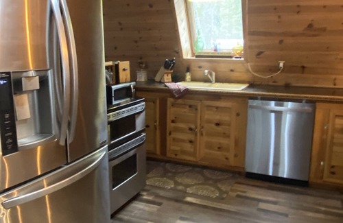 Paradise Cabin | Cozy Cabin nestled in the woods on all season road seconds from the trail system