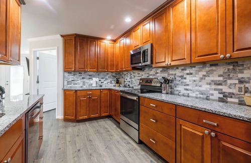 Radford House | Cozy home with a modern kitchen, spacious living, serene bedrooms, and a private deck for relaxation