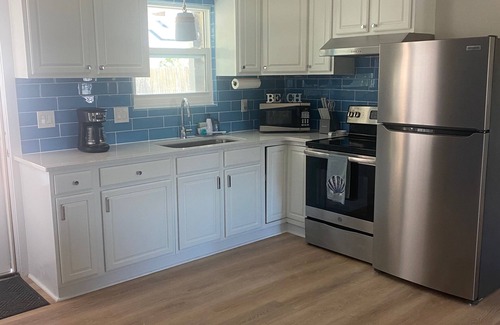 Riviera Beach House | Cozy House, Walk to Beach 🏖️ Large Deck w/Corn Hole & Sandbox 🪣 Pet Friendly🐶