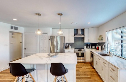 The Colony House | Dog-friendly remodeled home with full kitchen, outdoor pool, & arcade games