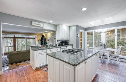McHenry House | Enchanting waterfront home with hot tub, game room, fireplace, & washer/dryer
