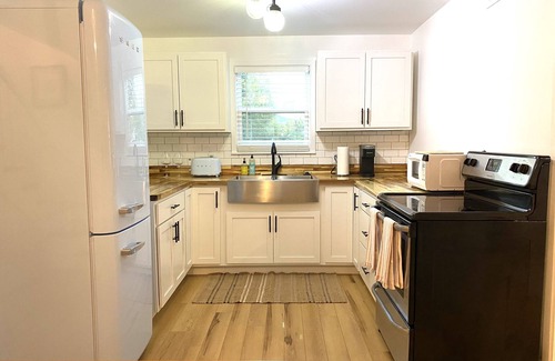 Mena Cottage | Experience History in an original Carriage House located behind a Colonial home.