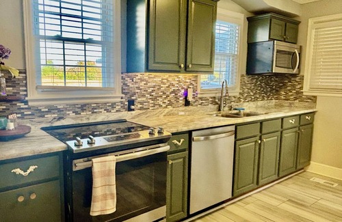 Whitsett House | Farmhouse with plush towels & linens, fully fenced for pets, playroom for kids