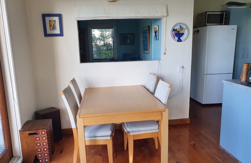 Mahurangi West Cottage | Iconic New Zealand beach cottage with elevated harbour and bush views.