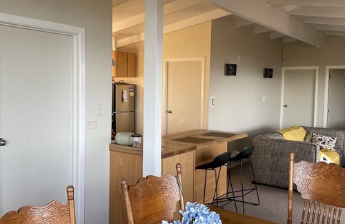 Orua Bay House | La Cachette is a charming Kiwi bach in native bush with stunning harbour views.