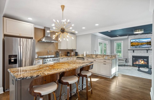 Commonwealth Park House | Luxury Charlotte Home with Stunning Pool & Hot Tub & Waterfalls