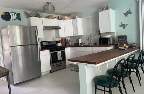 Bajo House | Malecon Beach House with beautiful backyard. Steps from the Caribbean ocean.