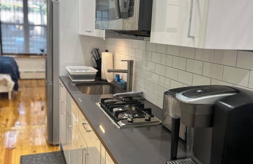 Upper Manhattan Apartment | Modern 1-bedroom Garden Apartment with Backyard, up to 25 mins to Times Square