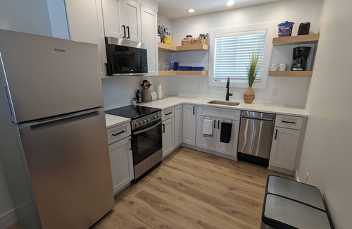 Carp Lake Cottage | NEW! Renovated lakeside cottage with a private sandy beach. Great Location!