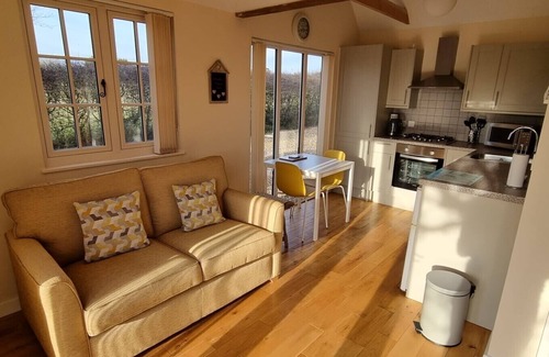 Alburgh House | One bedroom barn with open plan living area, private patio/garden,great sunsets