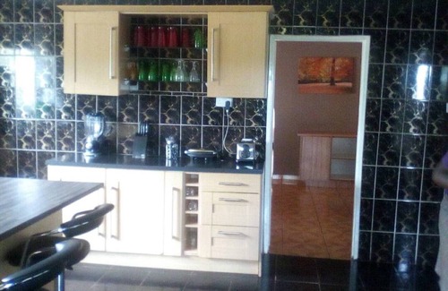Kwekwe House | Palm and rose garden, golden acres
