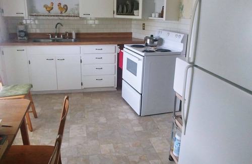 Emporia Apartment | Private Upper Deck surrounded by flower and vegetable gardens. Pet friendly
