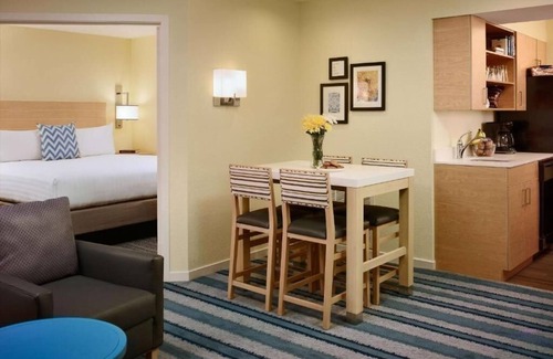 Somerset Hotel | Relax in Spacious Suite with Full Kitchen and Seasonal Swimming Pool