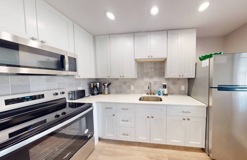 Madeira Beach Condo | Remodeled Florida Beach Cottage with Private Patio Area. Relax at the Pool. Walk Over to the Beach.