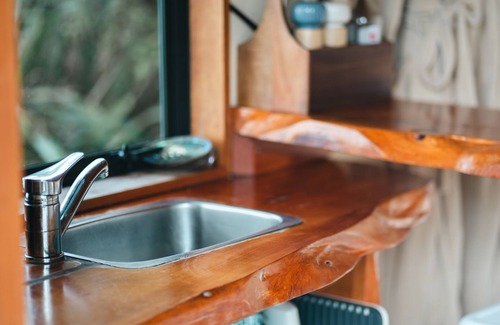 Nelson Region Cabin | Rocky Point Hut Pepin Island is nestled amongst native kanuka and coastal New Zealand bush