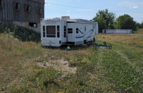 Asphodel-Norwood House | Serenity Lane Farm Stay: a trailer next to a barn full of farm animals
