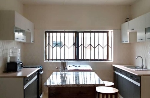 Kumasi Apartment | Sleeps8- Private Secure Parking- Garden- AirCon