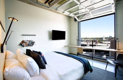 River North Art District Hotel | Spacious Industrial Loft with Stunning Views and Unique Garage Door Feature