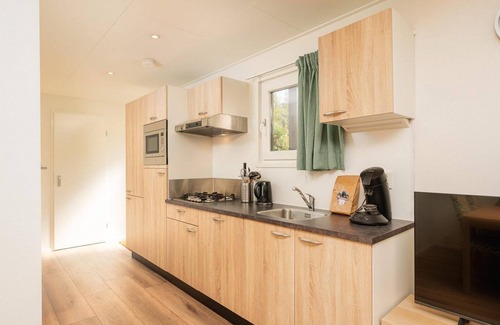 Lieren House | The Veluwe Lodge offers luxury and space for 5 guests with modern amenities in a serene, green setting.