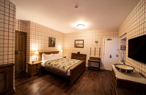 Shiel Bridge Bed & Breakfast | The wooden floors, vintage furniture, and tartan accents create a comfy room