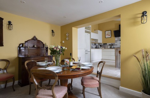 Minchinhampton Cottage | This charming Cotswold stone cottage, elegantly furnished with a seamless blend of antique and conte