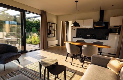 Lattrop House | This holiday home with a fully enclosed dog fence, private sauna and hot tub features a cosy, homely living room with open kitchen, 2 bedrooms and a spacious outdoor area.