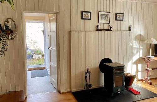 Dalmally House | Traditional farm cottage with woodburner by stream