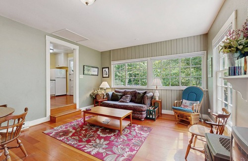 Molalla Cottage | Tranquil landscape with riverside firepit, gas grill, gas fireplace, and deck