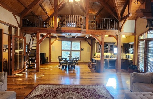 Sundance Cabin | Vaulted beam ceilings, a huge rock fireplace, stream nearby, large campfire area