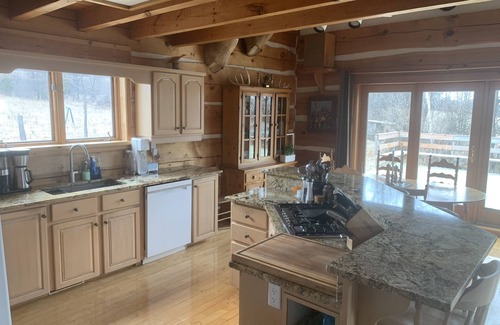 North Algona Wilberforce Cottage | Waterfront log home on Lake Dore. Decks, dock, outdoor hot tub and fire pit.