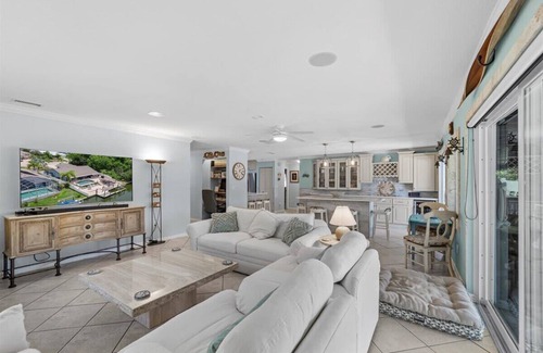 Palm Harbor House | Waterfront Retreat with Pool, Tiki Bar & Boat Dock