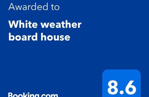 Henderson Villa | White weather board house