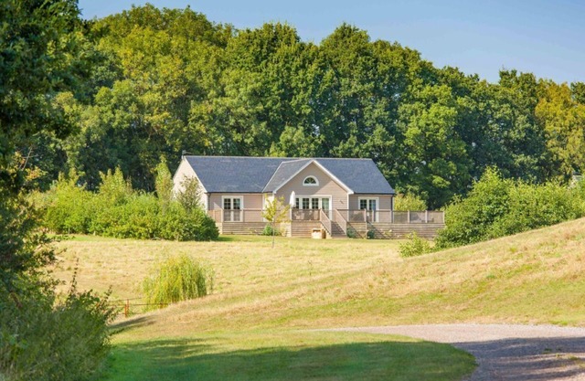 A delightful lodge with hot tub on Wakes Hall Farm is a haven of peace in 500 acres of private land