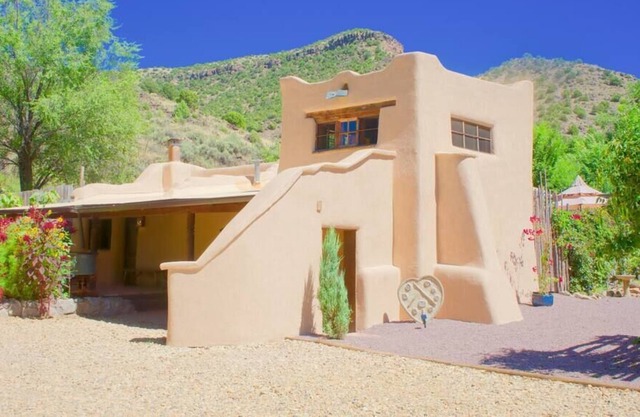 A romantic adobe, river retreat with outdoor tubs.