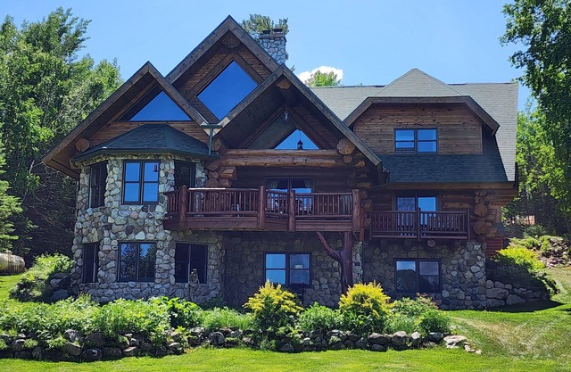 Beautiful handmade log home on private sand beach at the end of Big Bay