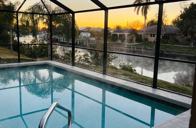 Beautifully updated home on canal with heated pool - no additional charge.