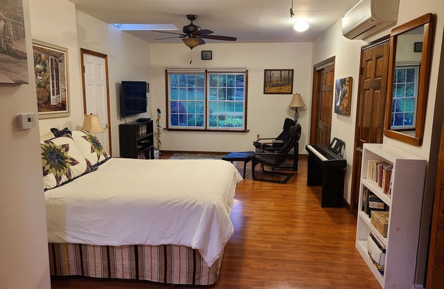 Bedroom, bathroom with beautiful shower, second room with work or eating area.