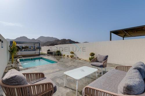 Blue Marble Beach 4BR Villa with Assistants Room, Private Pool, Access to Floating Pier, and Sea and Mountain Views, Al Dana Island, Fujairah by Deluxe Holiday Homes