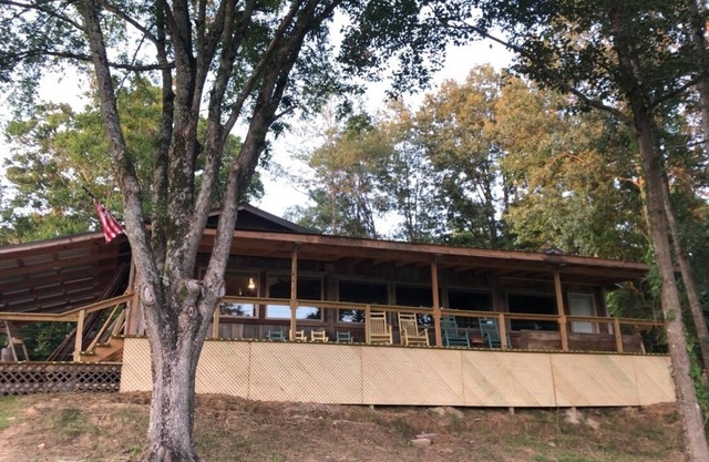 Cabin with 40 ft porch overlooking a pond.