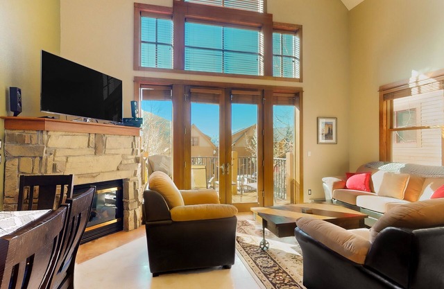 Centrally located with balcony, fireplace, heated garage parking & ski locker